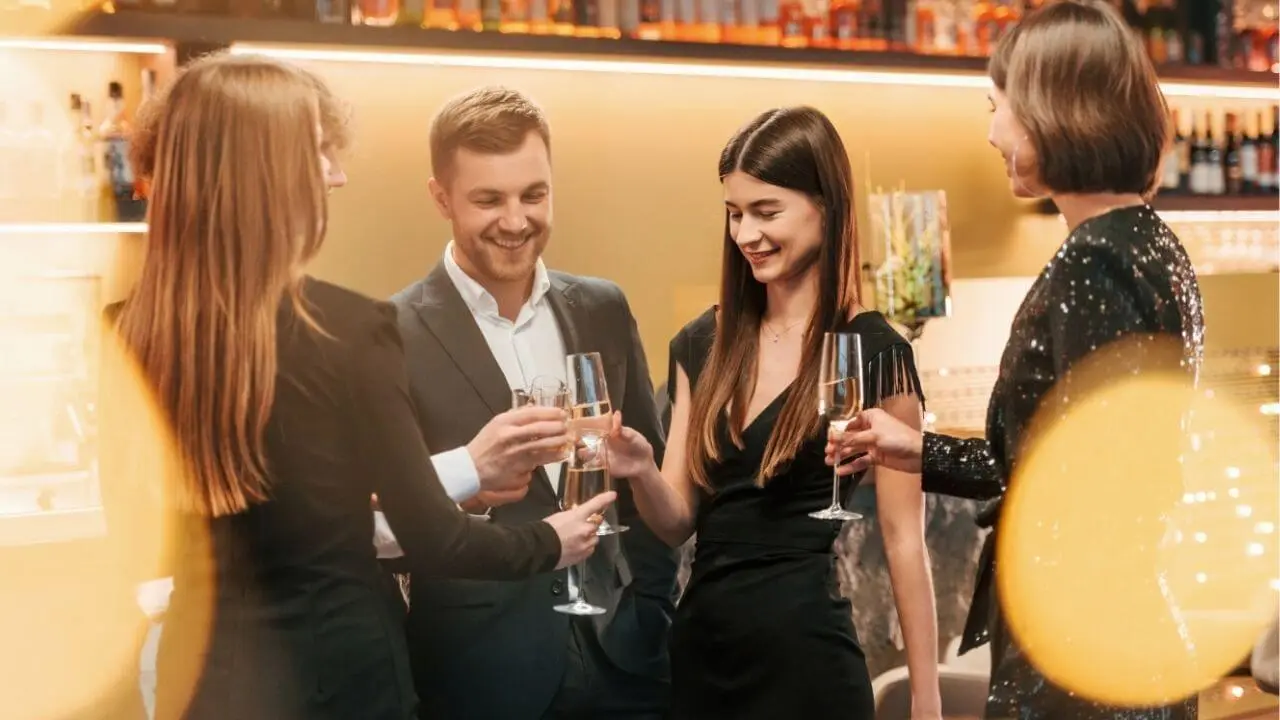 A group of elegant people toast together after being chauffeured by an NCC in Lecce.